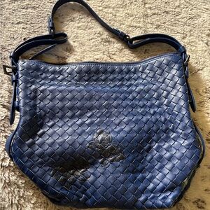 Bottega Veneta Navy Blue Hobo Bag with Woven Texture and Adjustable Strap.